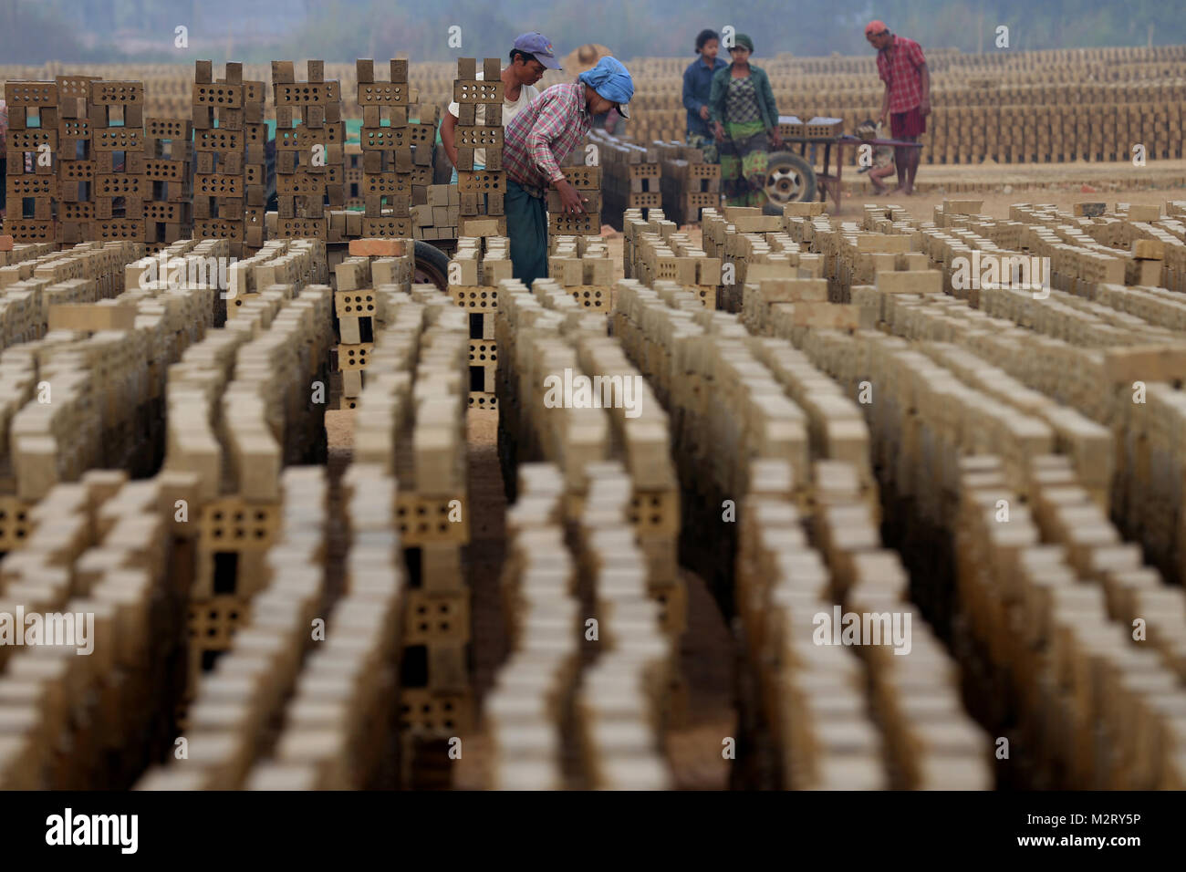 Yangon, Myanmar. 8th Feb, 2018. Laborers work at a brick factory on the outskirts of Yangon
