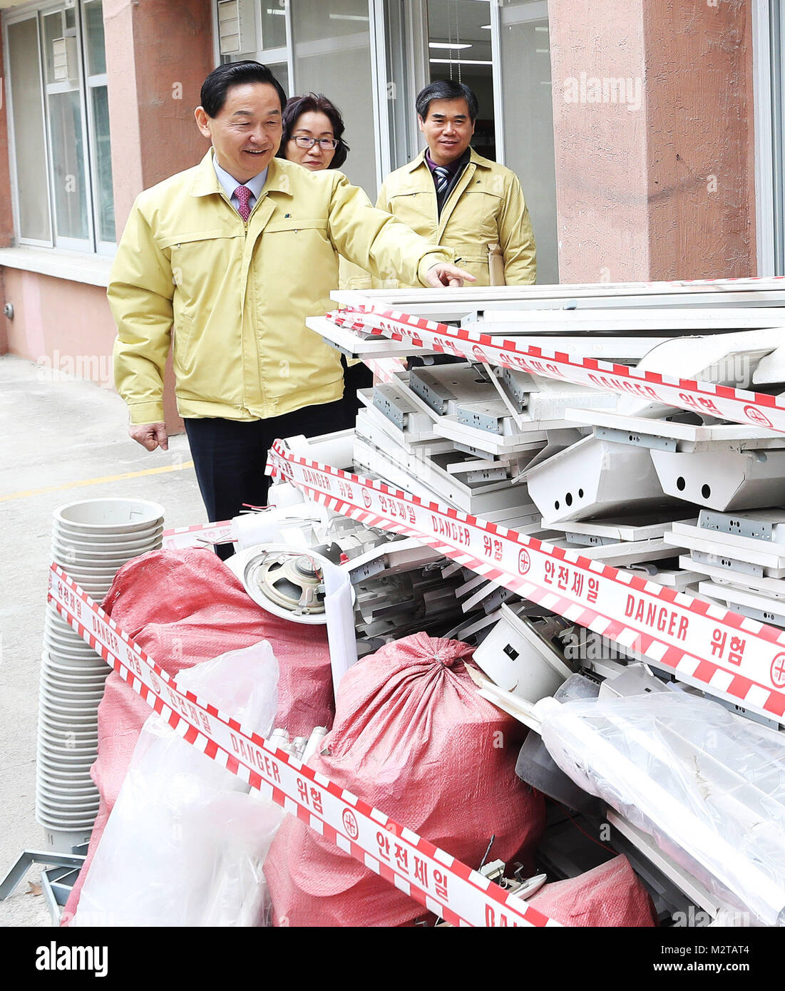 09th Feb, 2018. Education minister inspects removal of asbestos at school Education Minister Kim Sang-gon (C) views asbestos construction materials while visiting an elementary school in the city of Suwon, just south of Seoul, on Feb. 9, 2018, to inspect the school's removal of building materials that use asbestos. All forms of asbestos, a mineral fiber used in a variety of building materials, are known to be carcinogenic. Credit: Yonhap/Newcom/Alamy Live News Stock Photo