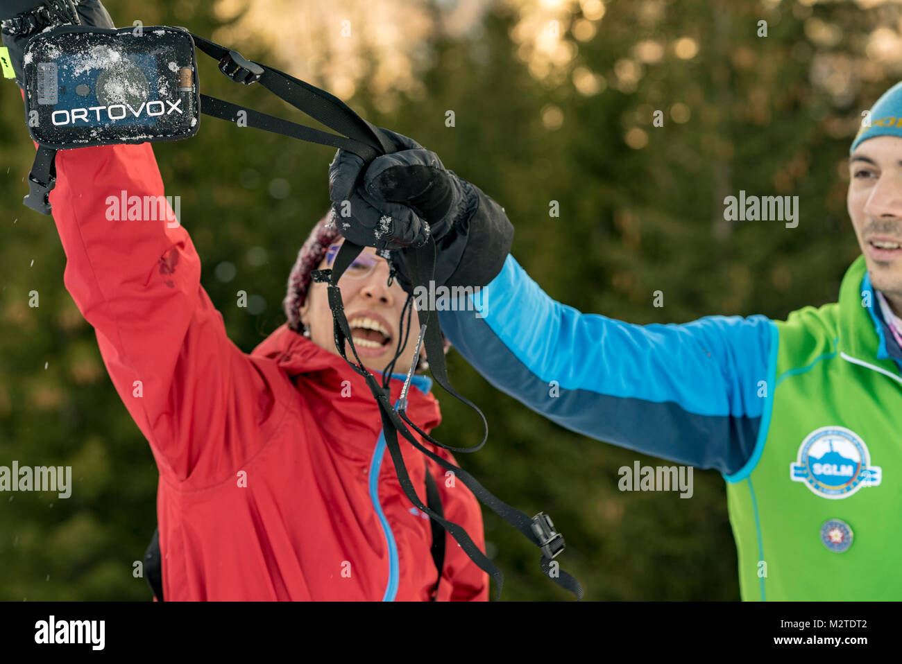 Mountain Leader explains how to avoid avalanches and how to use winter equipment to a group of people in the snowy mountains Stock Photo