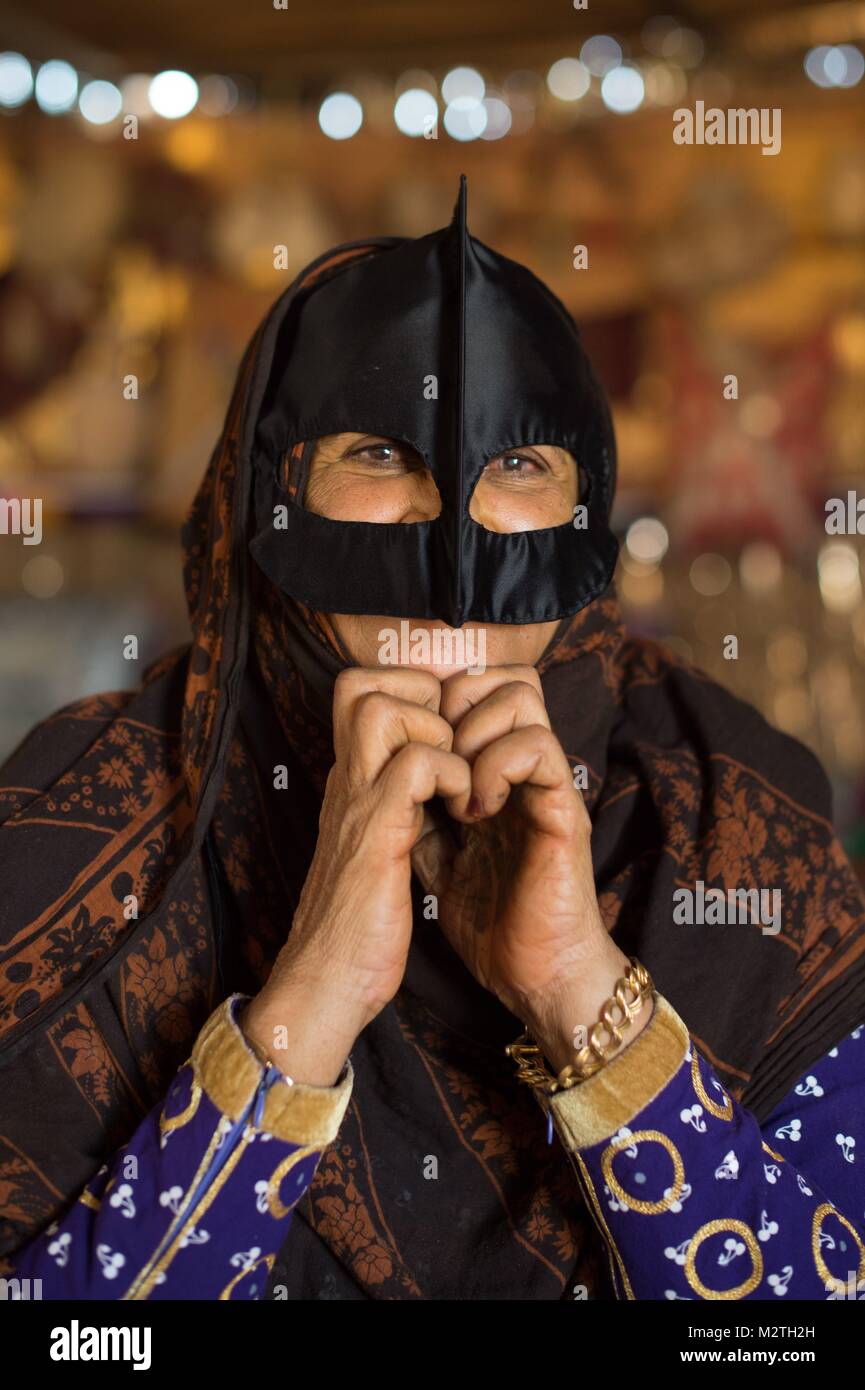 A Bedouin woman wearing an Omani burqa at Wahiba Sands desert near 