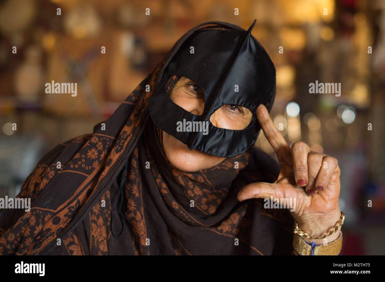 A Bedouin woman wearing an Omani burqa at Wahiba Sands desert near 