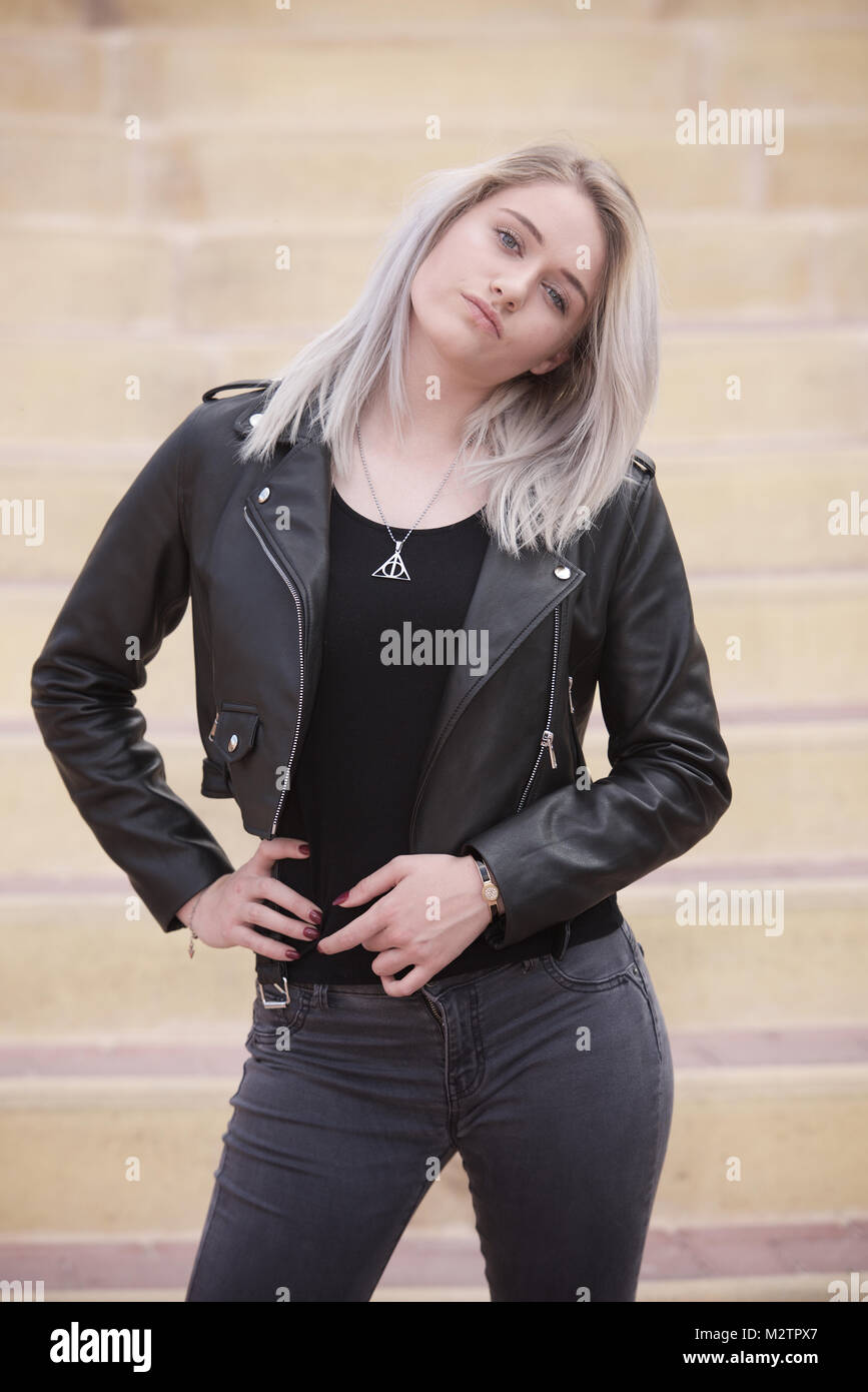 Beautiful blonde girl wearing tight jeans and a black t-shirt outdoors  Stock Photo - Alamy
