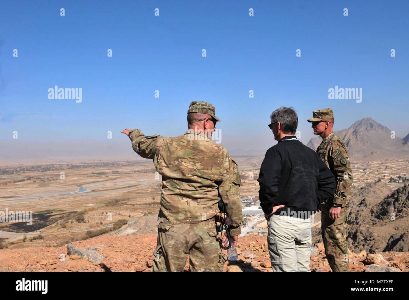 Col Todd Wood, commander of the 1st Stryker Brigade Combat team, 25th Infantry Division, and Command Sgt. Maj. Bernie Knight, CSM of the 1st Stryker Brigade Combat team, 25th Infantry Division, show Secretary of the Army John M. McHugh the view from the top of the mountain surrounding Forward Operating Base Masum Ghar on Dec. 14. US Army photo by Sgt. Michael Blalack, 1/25 SBCT Public Affairs 111214-A-AX238-019 by 1 Stryker Brigade Combat Team Arctic Wolves Stock Photo