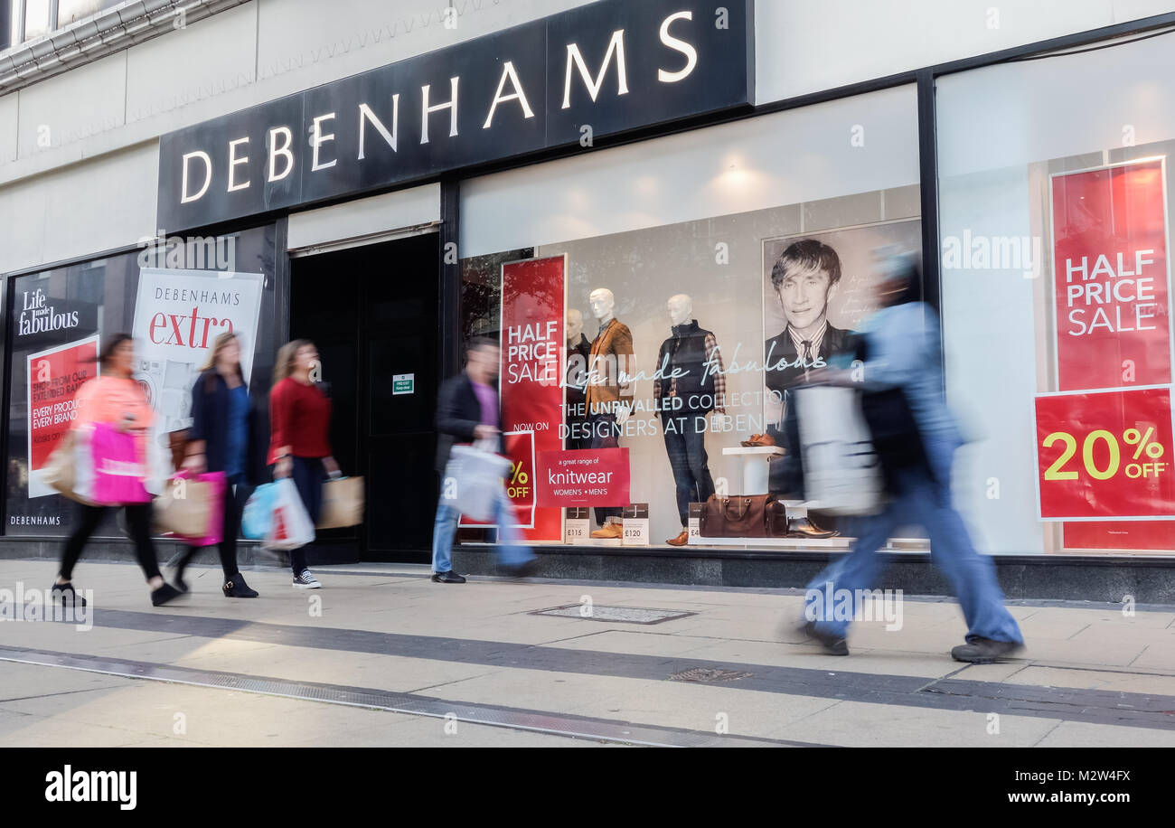 Shoppers walking past Jasper Conran window display in Debenhams store, Middlesbrough. UK Stock Photo