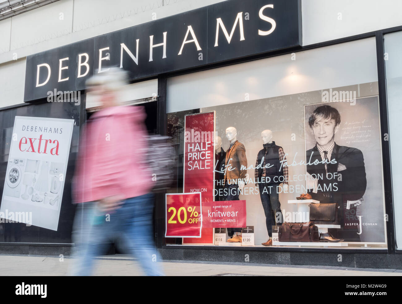 Shoppers walking past Jasper Conran window display in Debenhams store, Middlesbrough. UK Stock Photo