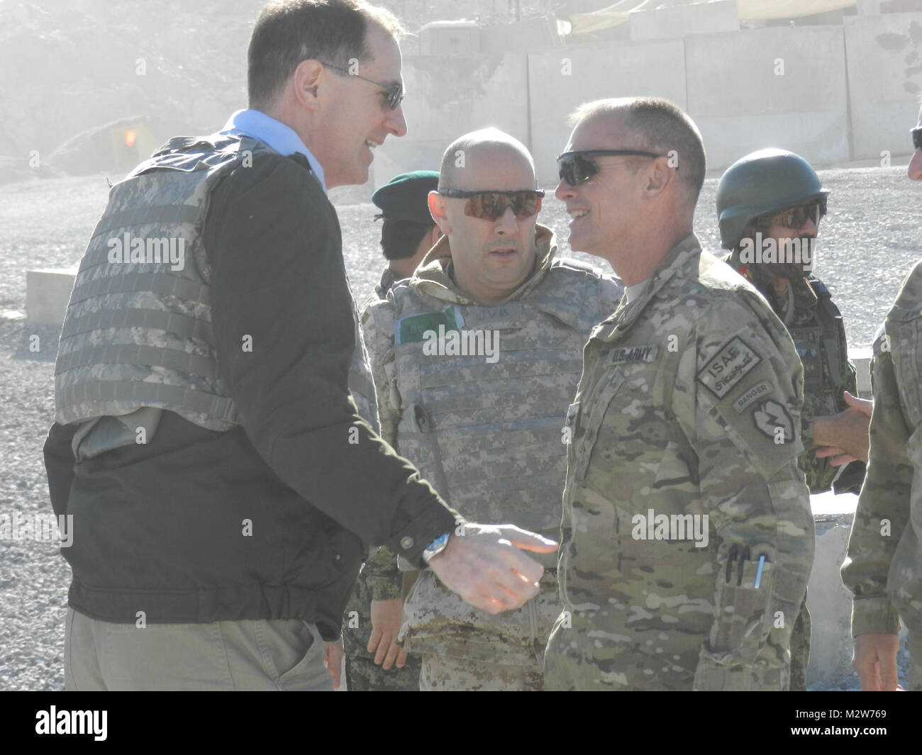 Col. Todd Wood, Commander of the 1st Stryker Brigade Combat Team, 25th Infantry Division, greets Dr. James Miller, Acting Under Secretary of Defense/ Principle Deputy Under Secretary of Defense for Policy, during Miller’s visit to Forward Operating Base Masum Ghar on March 8. (U.S. Army photo by Sgt. Michael Blalack, 1/25 SBCT Public Affairs.) 120308-A-AX238-001 by 1 Stryker Brigade Combat Team Arctic Wolves Stock Photo
