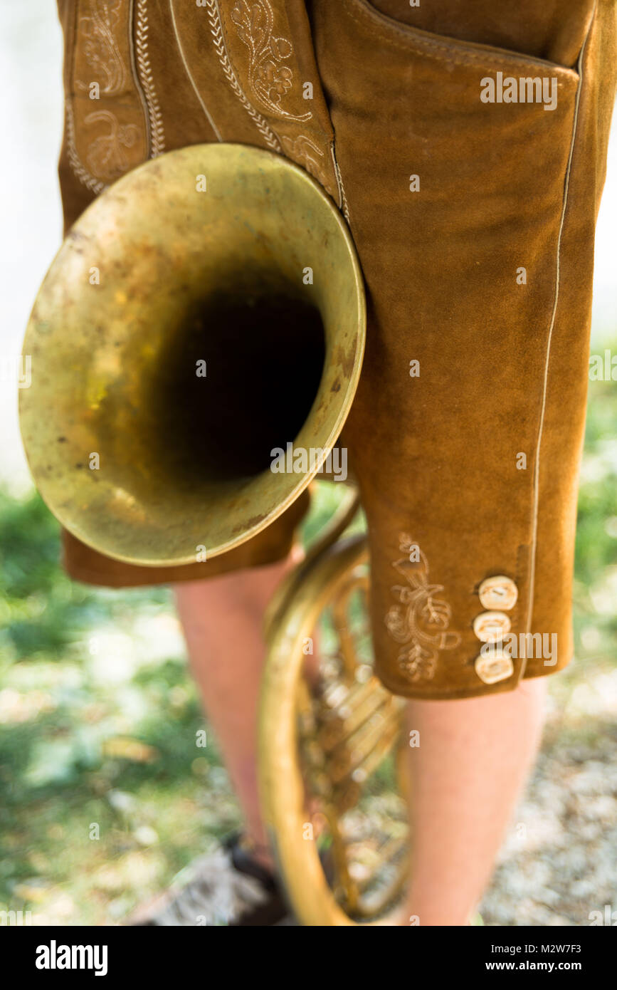 Man wearing Lederhosen, with tuba, detail Stock Photo
