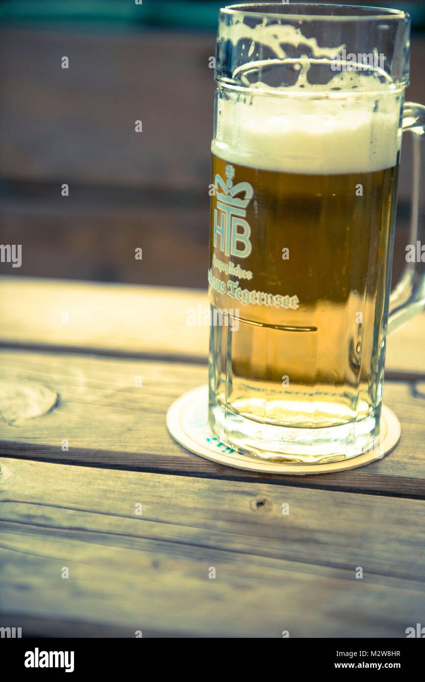 Beer glass, Tegernseer Bier on wooden table Stock Photo