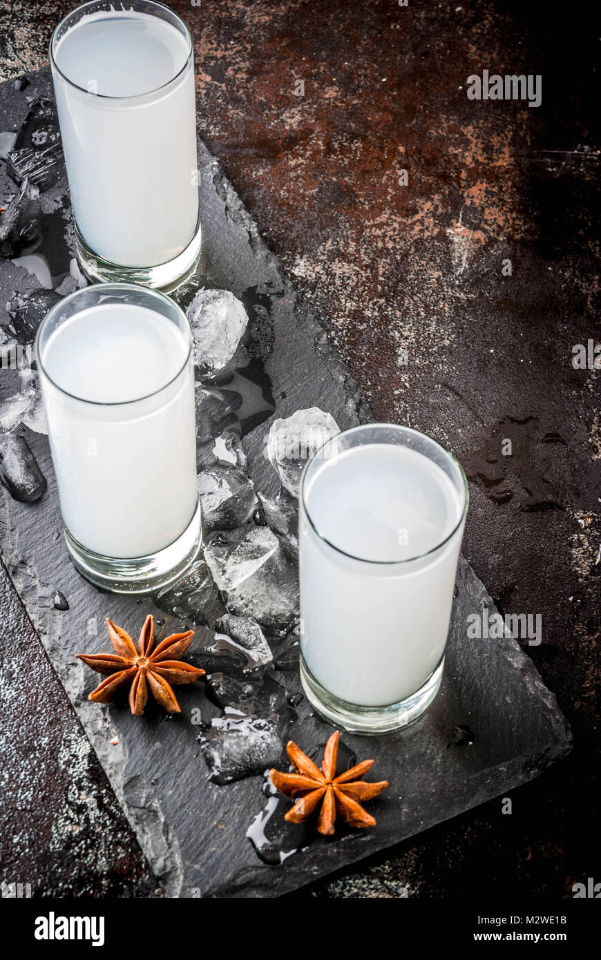 Traditional arabic alcohol drink Raki with anise, dark rusty background