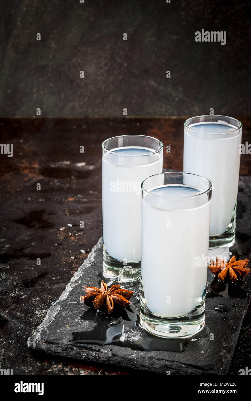 Traditional arabic alcohol drink Raki with anise, dark rusty background ...