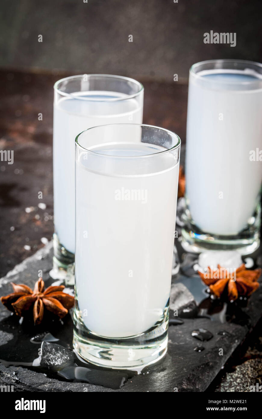 Traditional arabic alcohol drink Raki with anise, dark rusty background