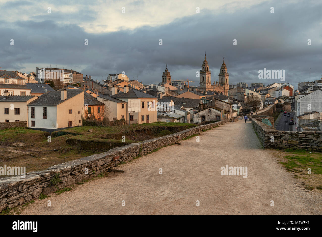 Cathedral of Santa Maria from the wall of the city of Lugo, Galicia region, Spain, illuminated in the sunset Stock Photo