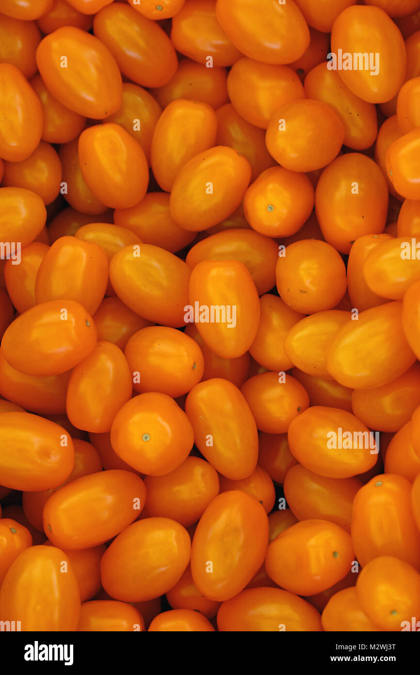 Close up fresh yellow cherry tomatoes at retail display of farmers ...