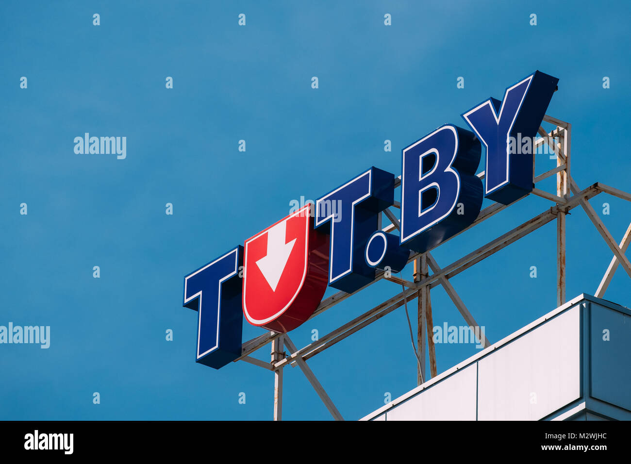 Minsk, Belarus. Logo Logotype Sign Of Tut.By On Roof Of Building On Background Of Blue Sky. Minsk-based Internet Portal In Belarusian And Russian Lang Stock Photo