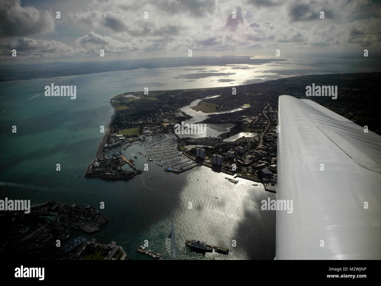 AJAXNETPHOTO. 24TH AUGUST, 2011. PORTSMOUTH, ENGLAND. - THE SOLENT - LOOKING WEST OVER A GLISTENING SOLENT. THE ENTRANCE TO PORTSMOUTH HARBOUR IS IN THE FOREGROUND LOWER LEFT.  PHOTO;JONATHAN EASTLAND/AJAX REF:R110709 2129 Stock Photo