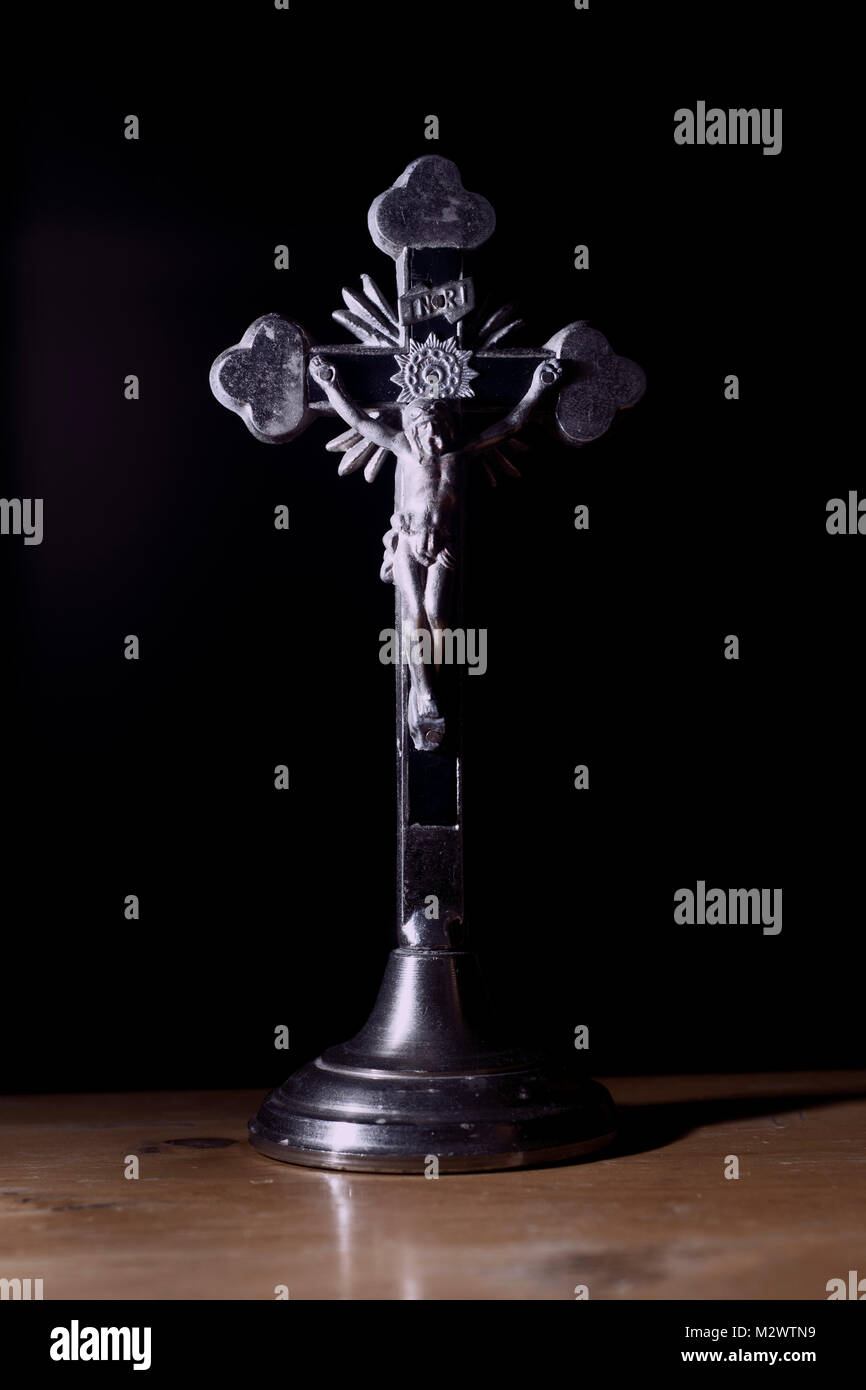 Metal crucifix on a black background Stock Photo - Alamy