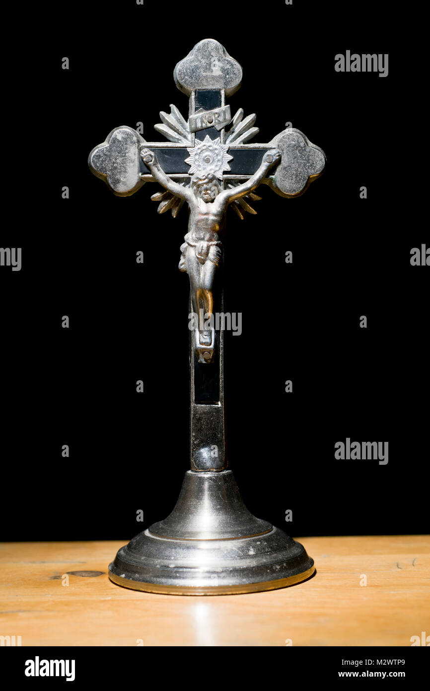 Metal crucifix on a black background Stock Photo - Alamy