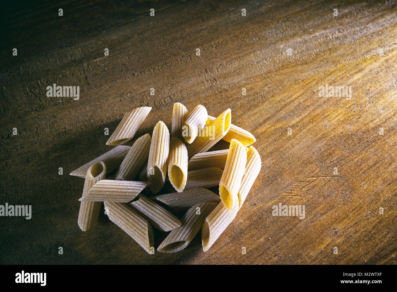 Penne pasta on wooden table, top view Italian culture Stock Photo Alamy