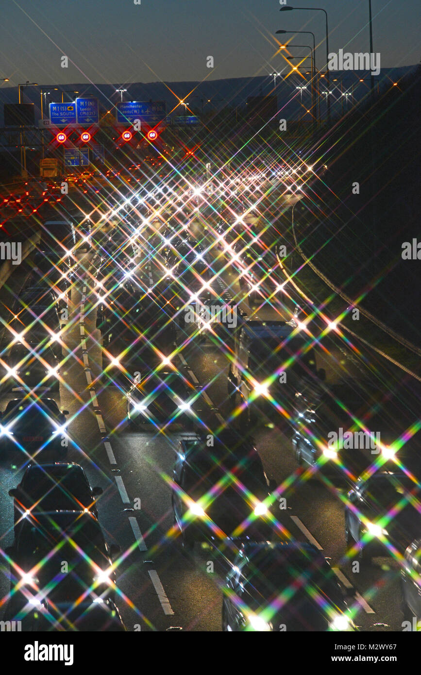 traffic jam by reduced speed limit and speed camera warning signs and