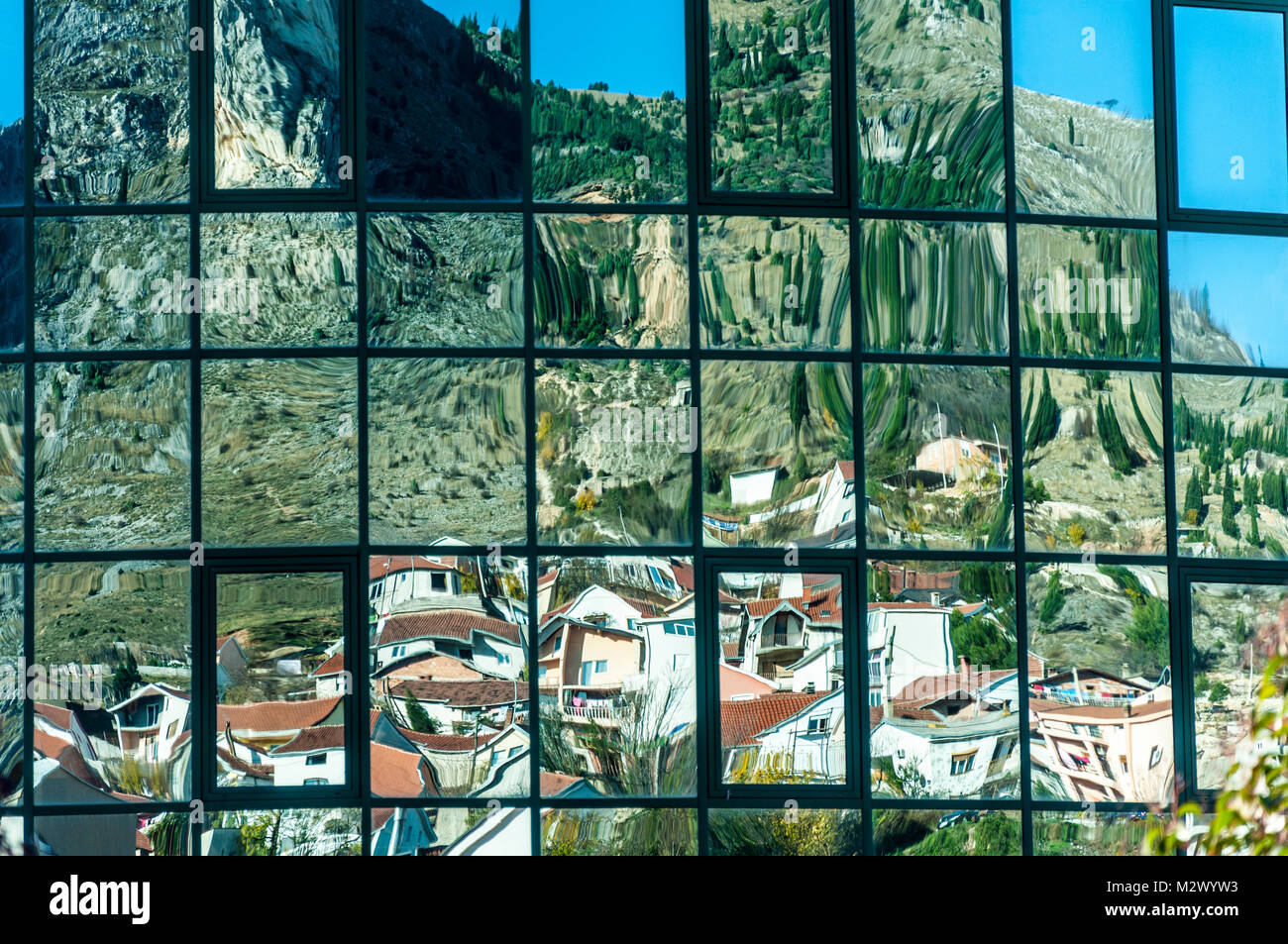Homes and houses reflected in modern office windows in Mostar, Bosnia Hercegovina, Former Yugoslavia Stock Photo
