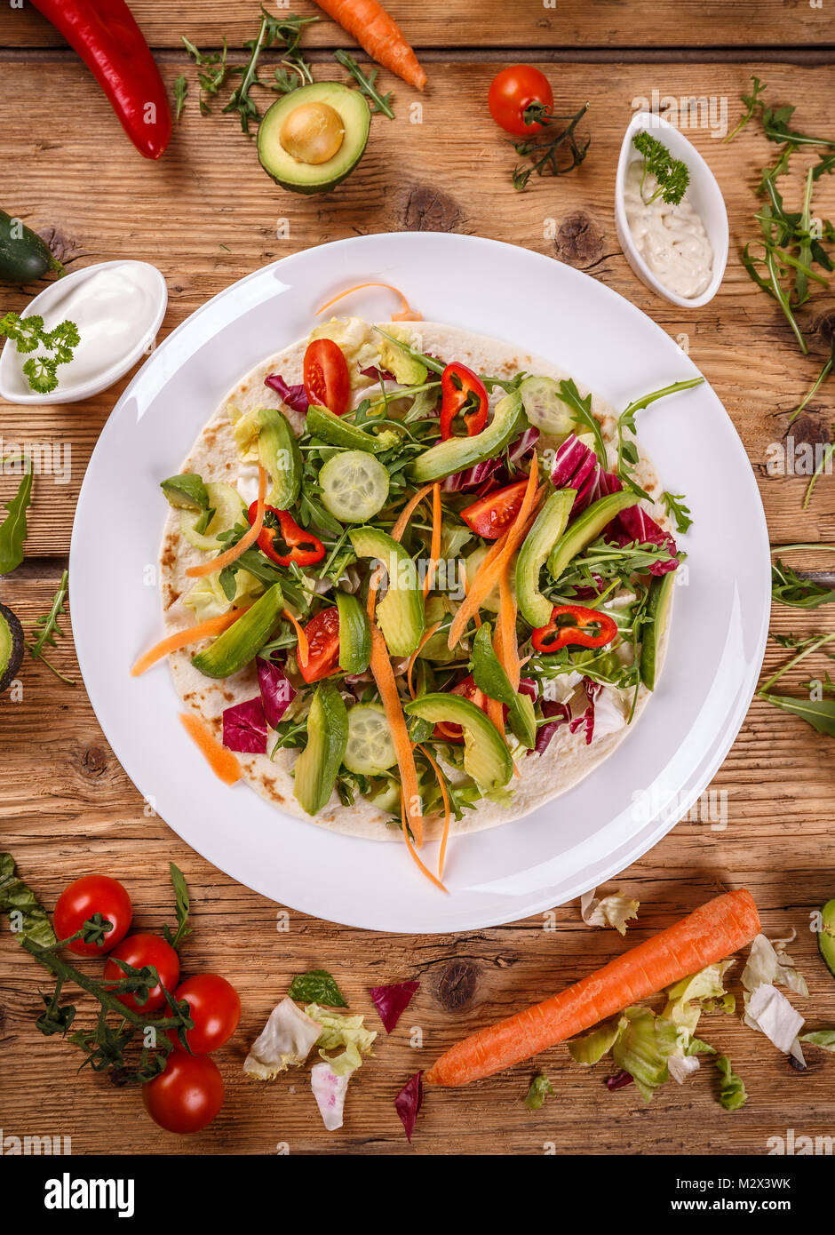Healthy vegan salad tortilla wraps on wooden background Stock Photo