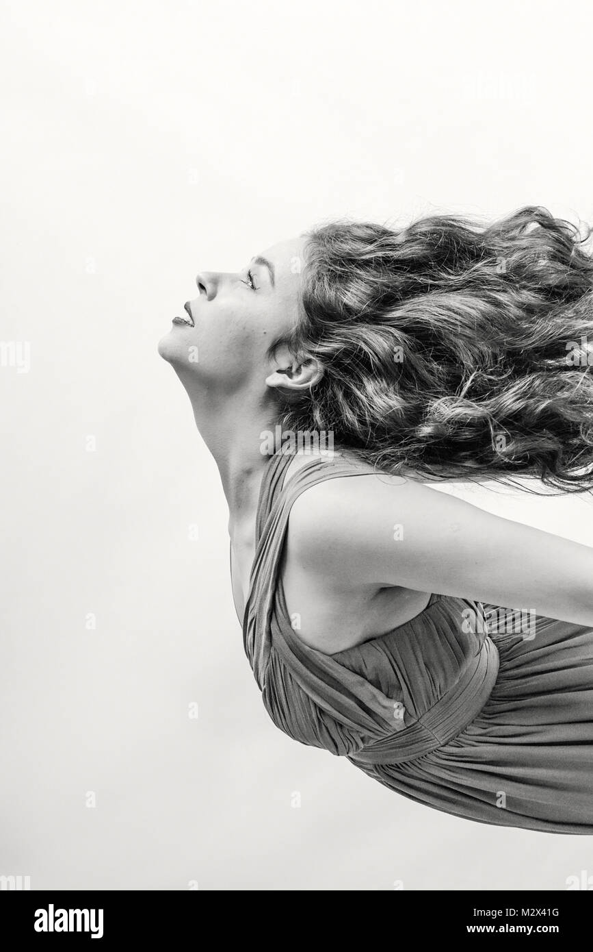 Beautiful Classically Dressed Young Girl Dances Across A Grey