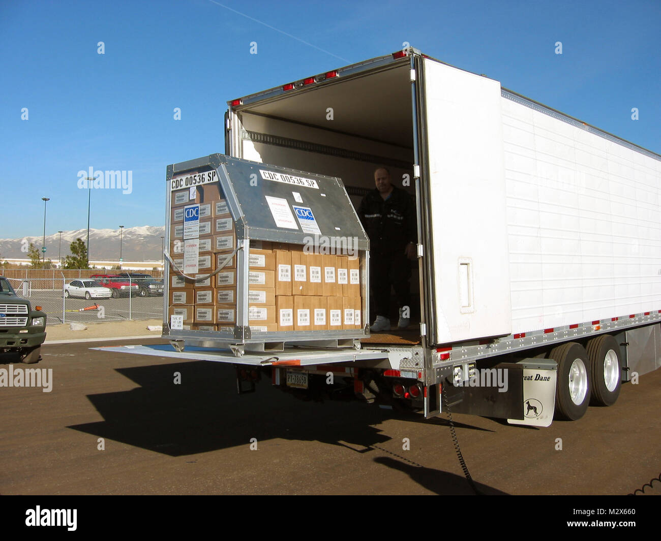 This image, was captured at an undisclosed location, and depicts a Strategic National Stockpile (SNS) staff member inside an eighteen-wheeled transport truck, who was in the process of off-loading what’s known as, a 12-hour Push-Package, which contained vital medical supplies to this unidentified region. These modular containers are ready-made for shipment, while still at the SNS warehouse. This module was not locked to its metal palette, which allowed for its mobility, though would be during its shipment. Stock Photo