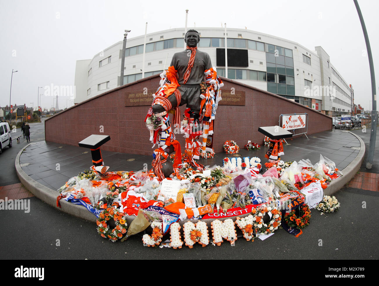 General view of tributes left at the Jimmy Armfield statue ahead of his funeral cortege which will pass through Bloomfield Road in Blackpool later today. Stock Photo