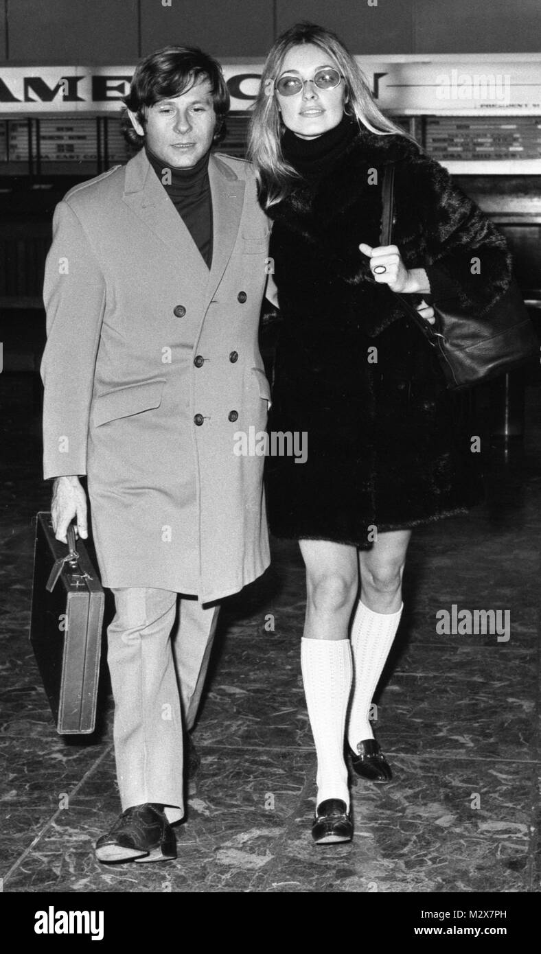Actress Sharon Tate, 25, who stars in the film 'Valley of the Dolls', wearing tinted glasses and long white knitted socks, as she arrived at Heathrow Airport, London, with her husband-to-be, Roman Polanski. They are to marry on Saturday. Stock Photo