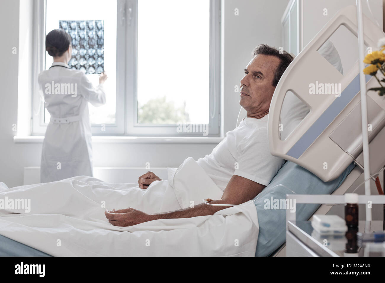 Exhausted man dreaming while lying in hospital bed Stock Photo Alamy