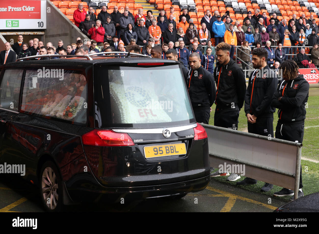 Blackpool fans and players look on as the funeral cortege for Jimmy
