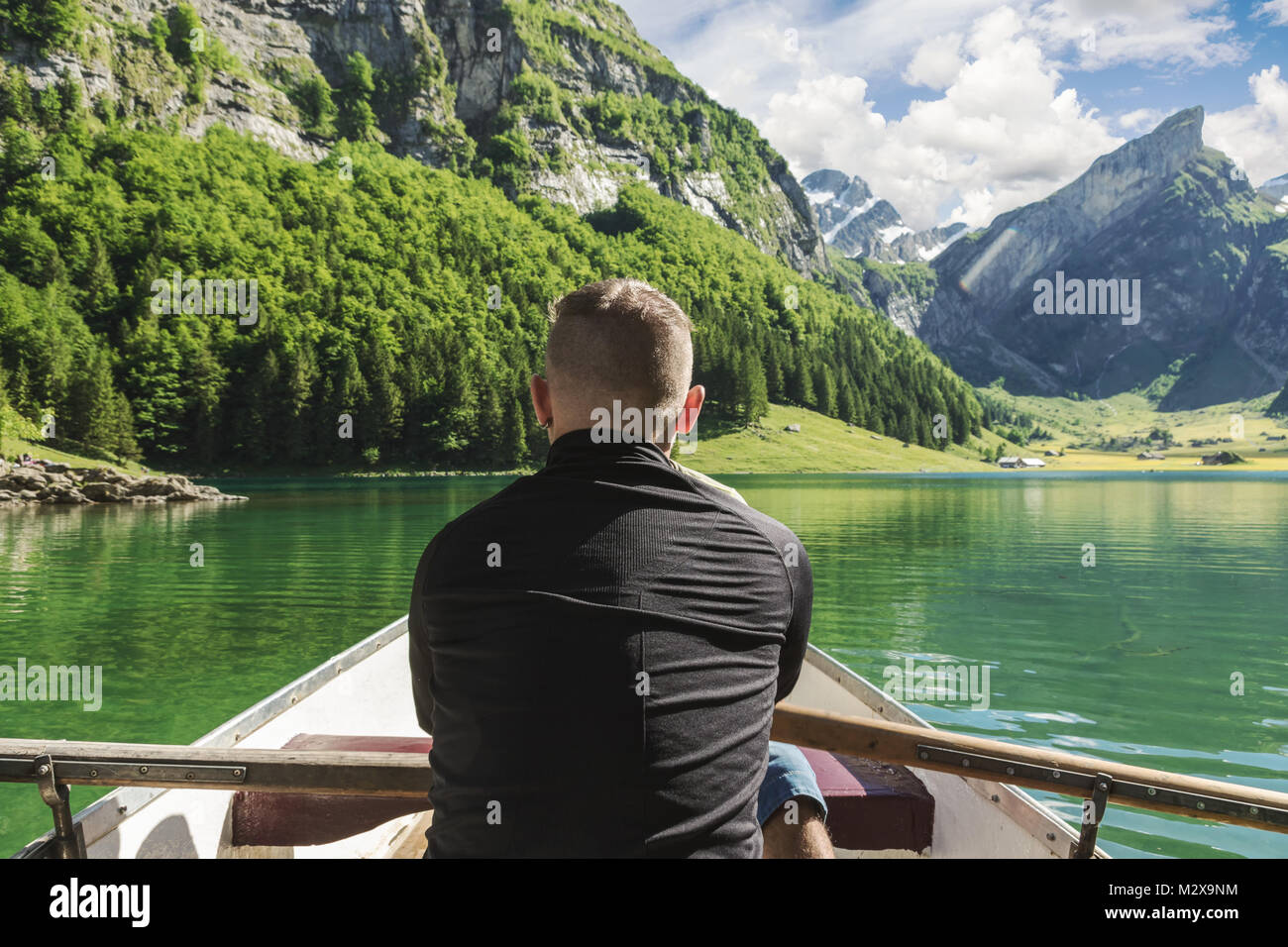 back of rower in front beautiful Seealpsee lake and Alpstein mountain in Appenzell, Switzerland Stock Photo