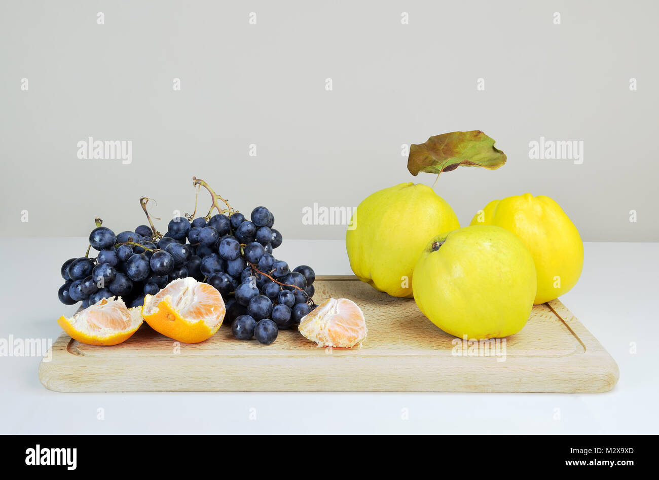 Concept with  quinces, grapes and mandarins Stock Photo
