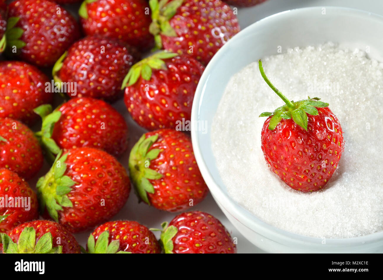 A fresh strawberry in sugar Stock Photo Alamy