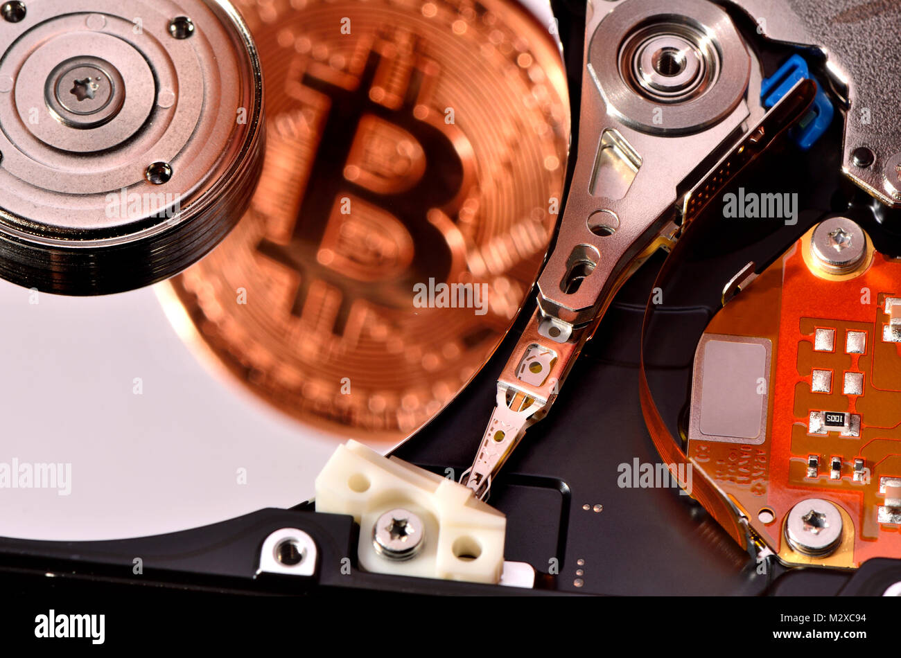 Bitcoin cryptocurrency / payment system (Copper Bitcoin Commemorative Round .999 bullion) Electronic currency - computer hard drive; Stock Photo
