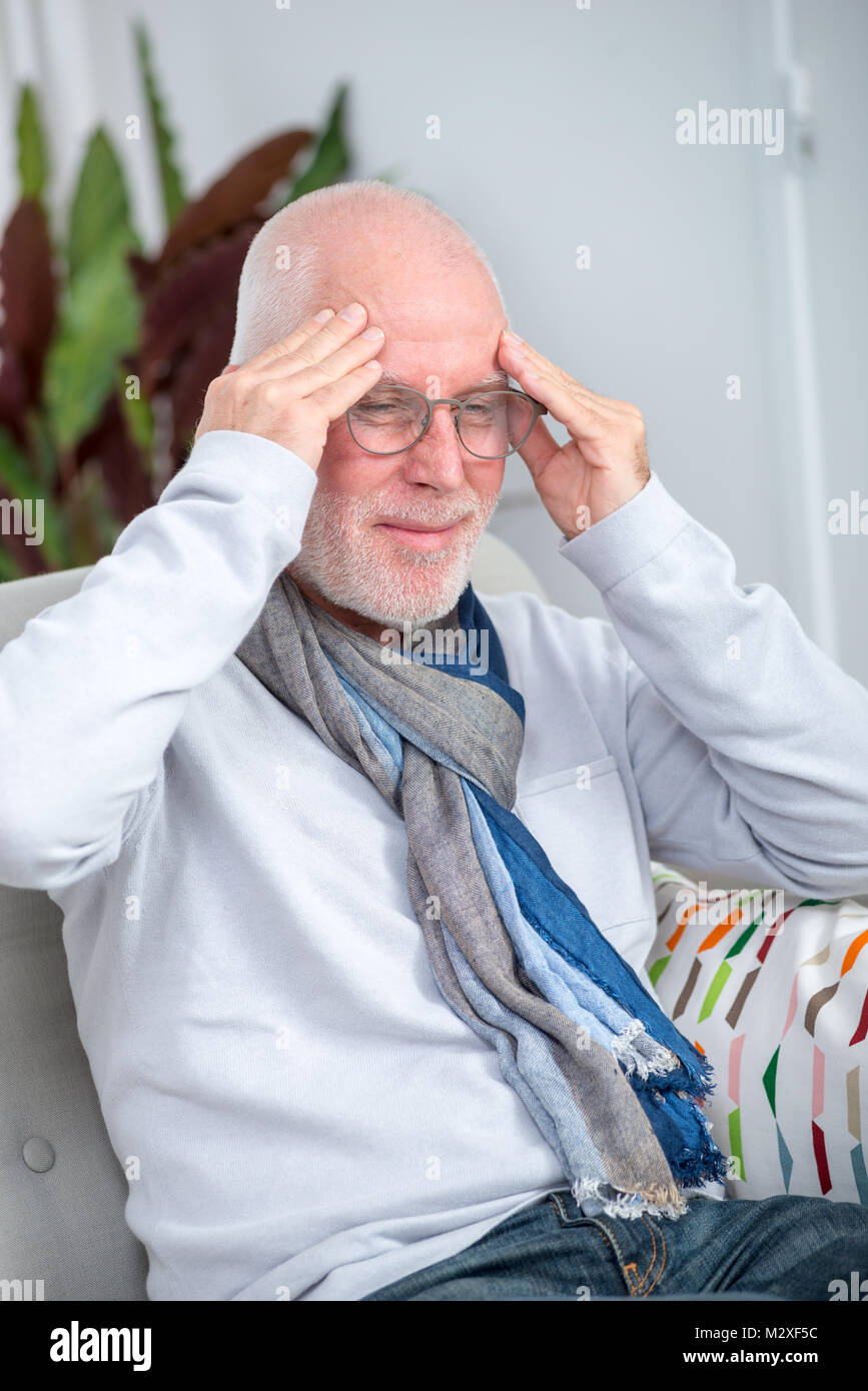 a senior man suffering from headache at home Stock Photo - Alamy