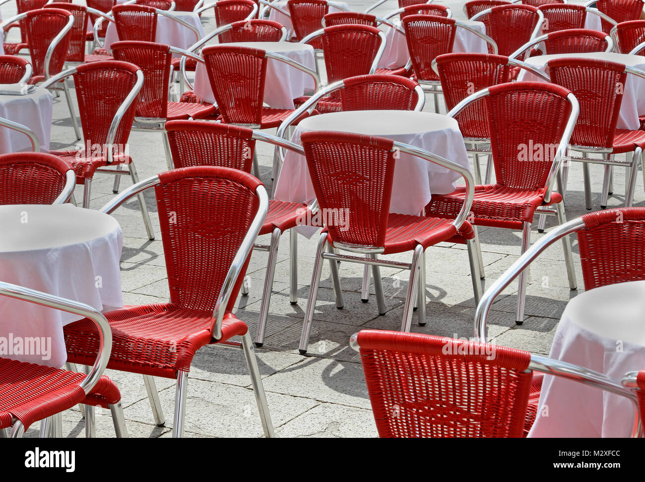 Red chairs in outside terrace restaurant seating section Stock Photo