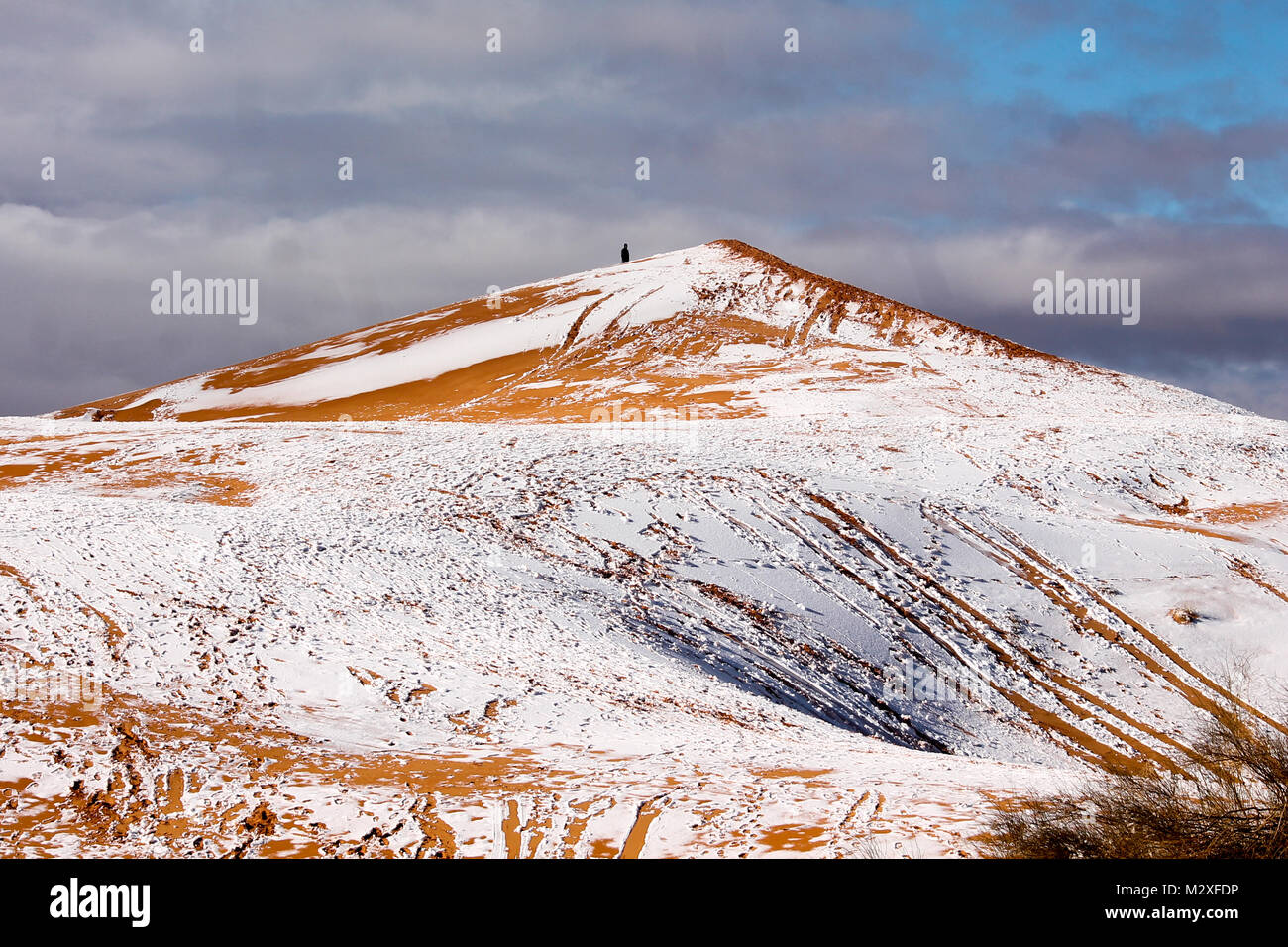 The snow in the Sahara Desert on Tuesday morning (Feb 6th) near Ain Sefra ,Algeria.The snow fell on Monday afternoon but has yet to melt,normally the snow melts within hours of it falling.  Locals were stunned to see snow on the SAND DUNES in the Sahara Desert  after it snowed for the second time this year, following nearly four decades without it. Stock Photo