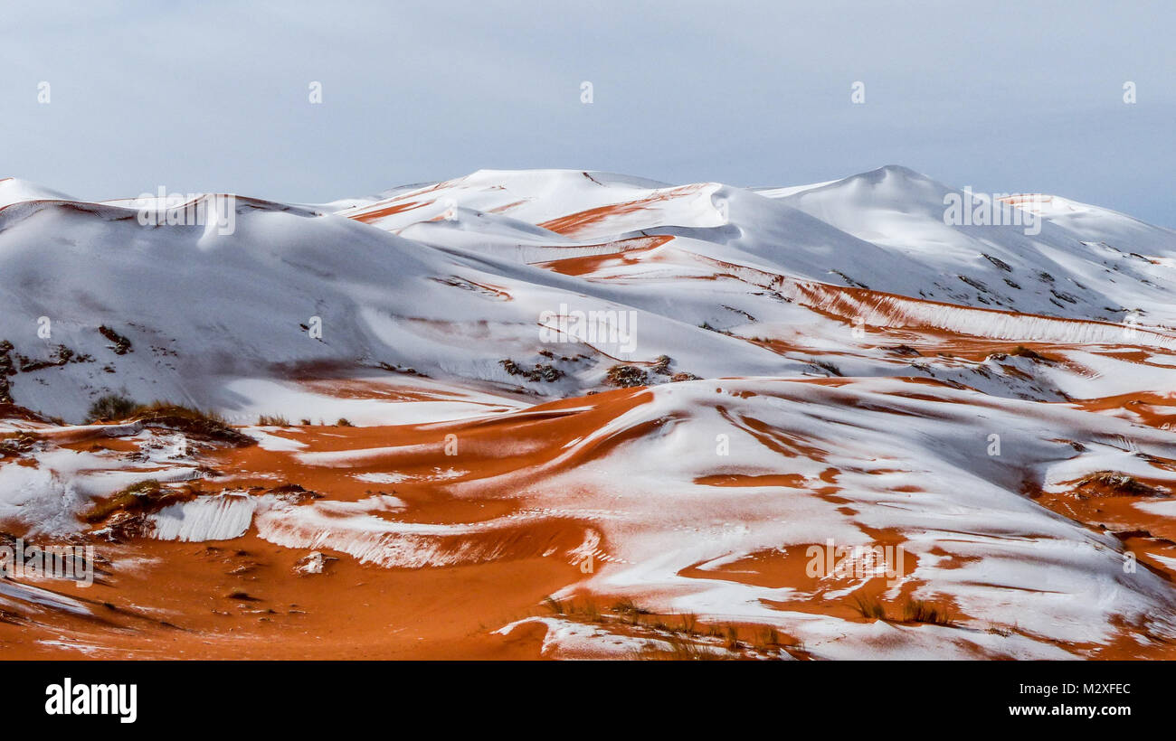 The snow in the Sahara Desert on Tuesday morning (Feb 6th) near Ain Sefra ,Algeria.The snow fell on Monday afternoon but has yet to melt,normally the snow melts within hours of it falling.  Locals were stunned to see snow on the SAND DUNES in the Sahara Desert  after it snowed for the second time this year, following nearly four decades without it. Stock Photo