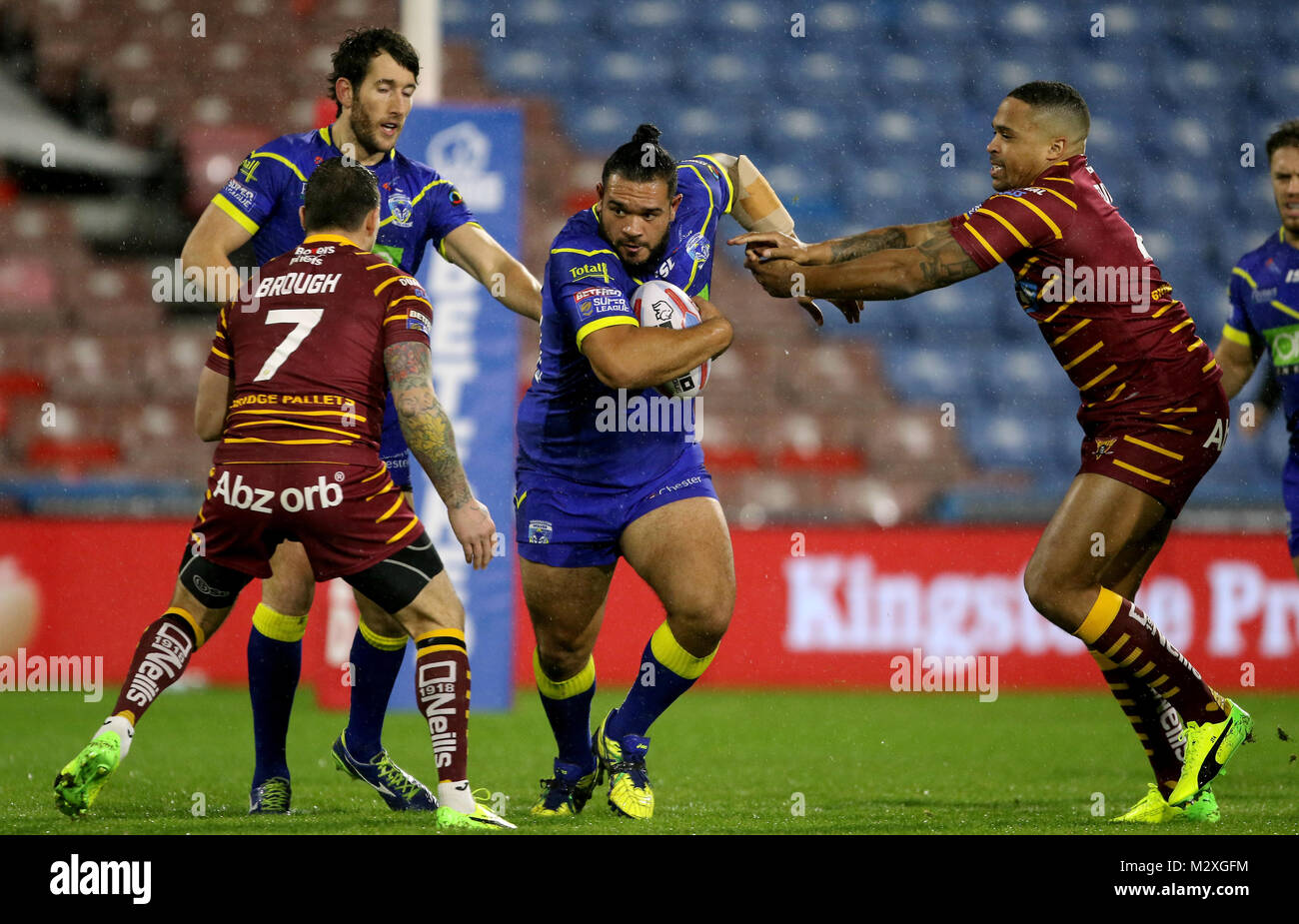Warrington's Ben MurdochMasila is challenged by Huddersfield Giants