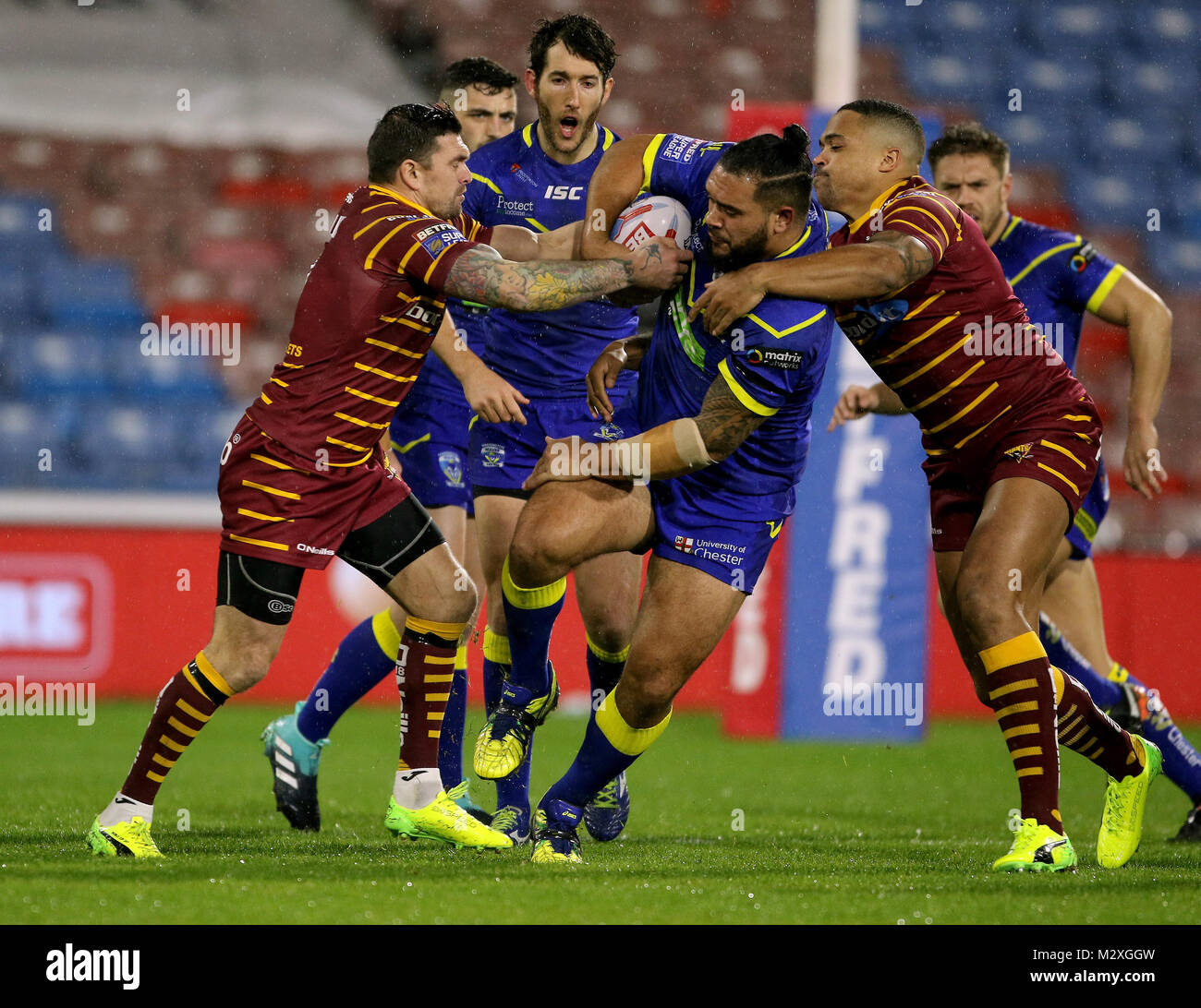 Warrington's Ben MurdochMasila is challenged by Huddersfield Giants