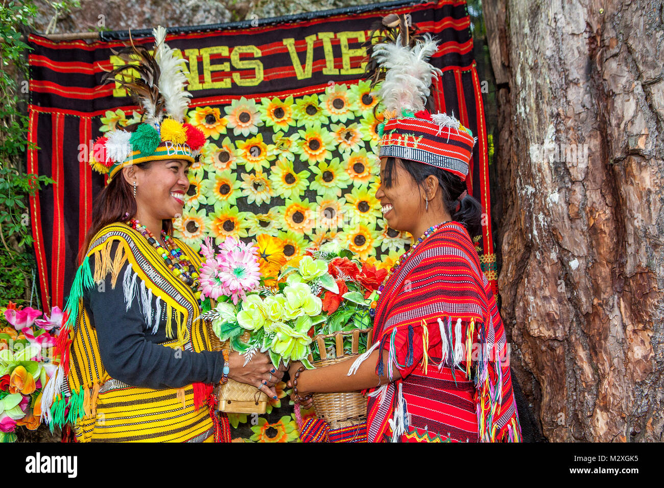 Two Filipino women tourists dress in traditional Ifugao indigenous peoples' costumes at Mines View Park in Baguio City, Luzon, Philippines. Stock Photo
