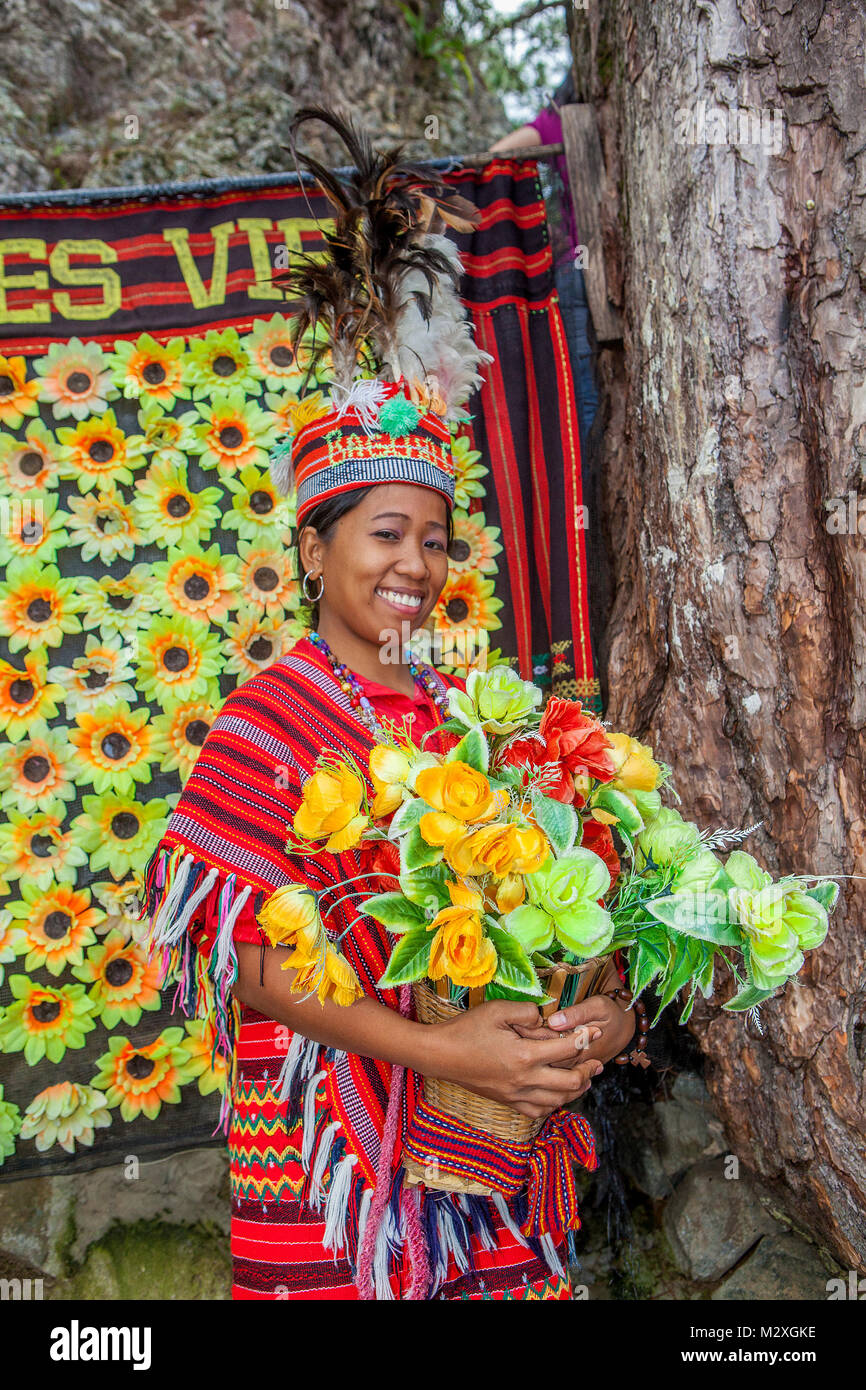 A Filipino tourist dressed in Ifugao traditional costume poses for photos at a kiosk at Mines View Park in Baguio City, Luzon, Philippines. Stock Photo