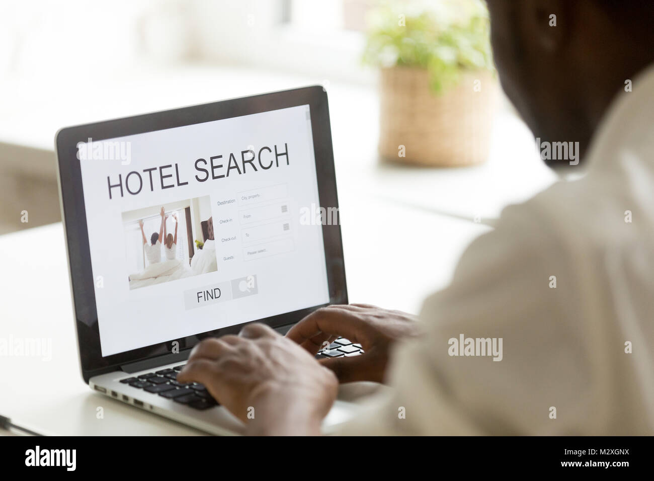 African american man browsing hotel online for business or holiday vacation using web search app on laptop computer website engine, black businessman  Stock Photo