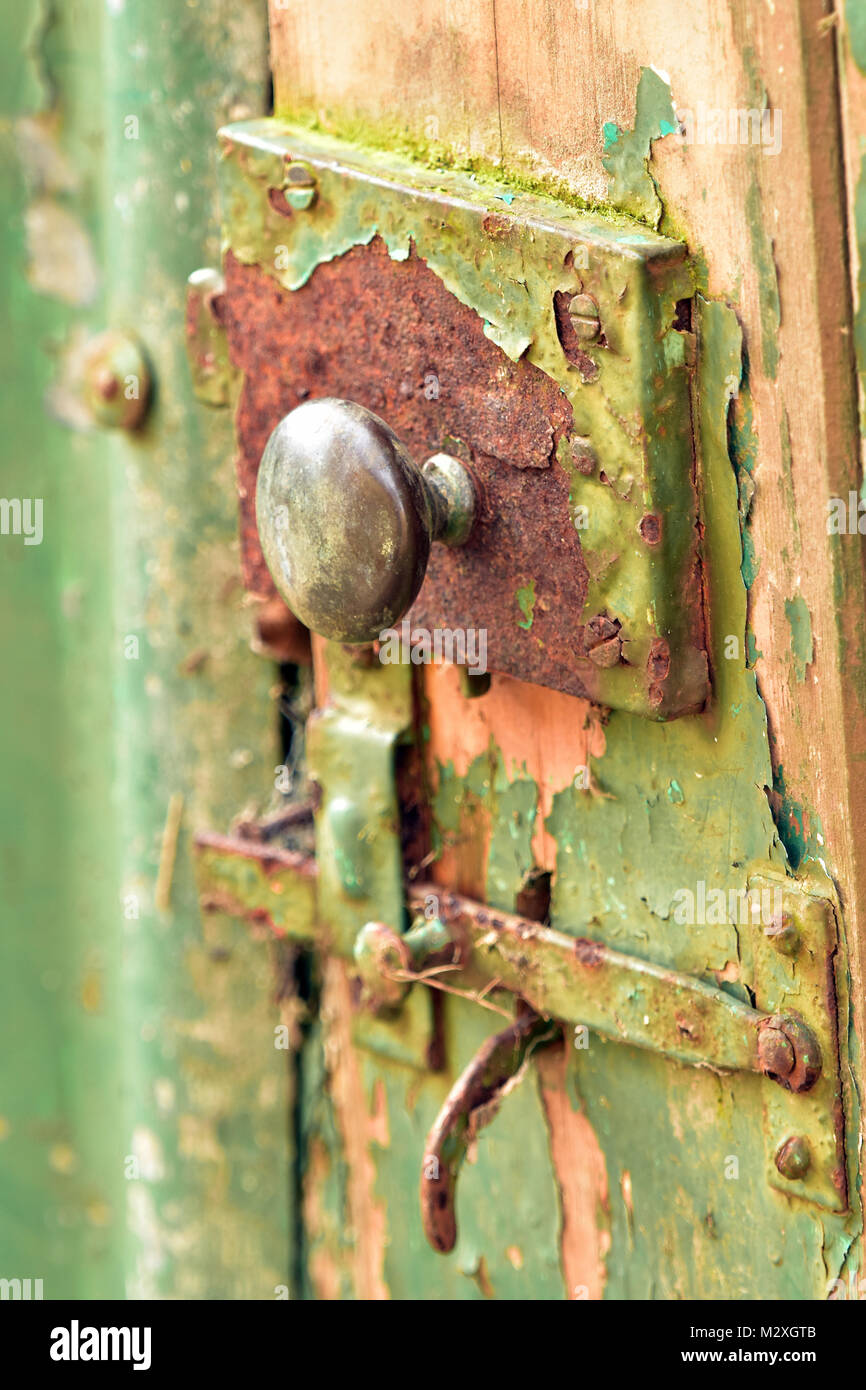 a rusty old vintage door handle on an old garden shed with rusty lock and  peeling paintwork in a shabby chic style. garden shed outbuilding latch  lock Stock Photo - Alamy