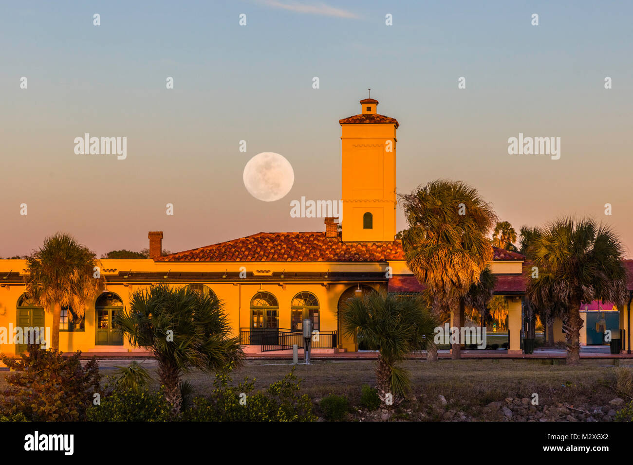 Moon coming up over historic Venice Seaboard Air Line Railway Station also known as the Venice Train Depot in Venice Florida United States Stock Photo