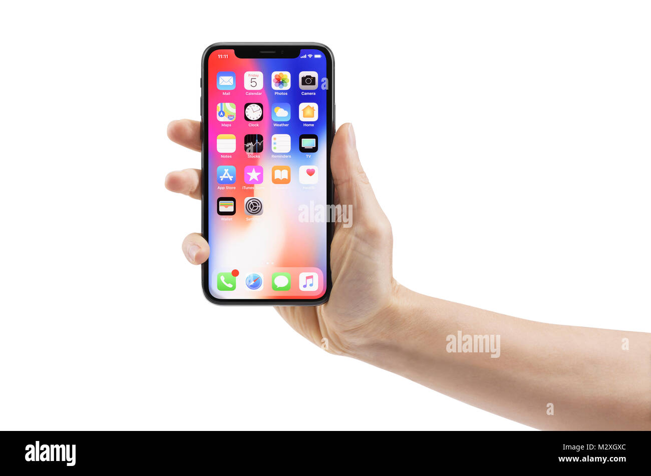 Woman hand holding Apple iPhone X, large screen smartphone, with colorful blue red desktop on its display. The phone is isolated on white background w Stock Photo