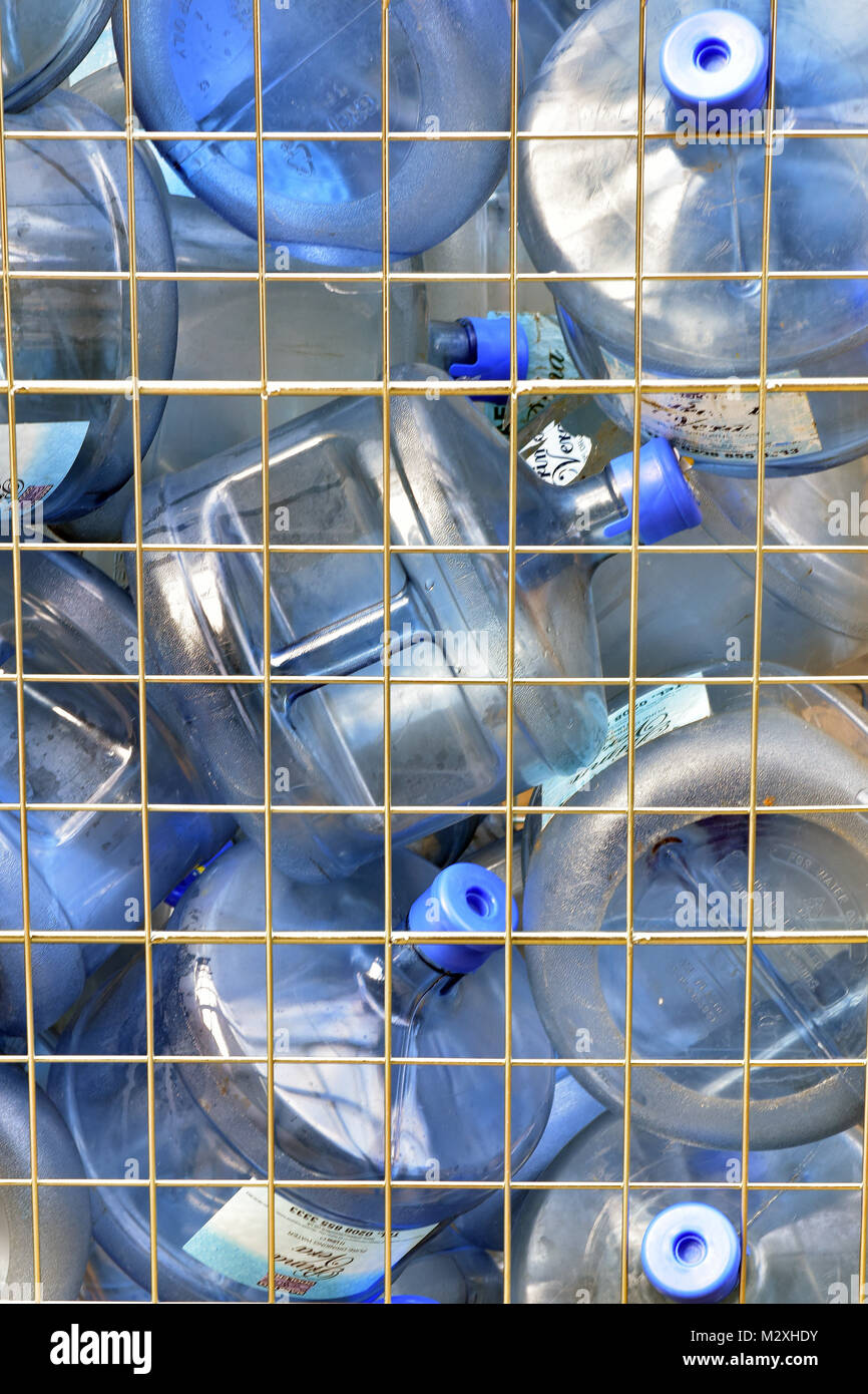 Large plastic water bottles being collected and delivered to a business