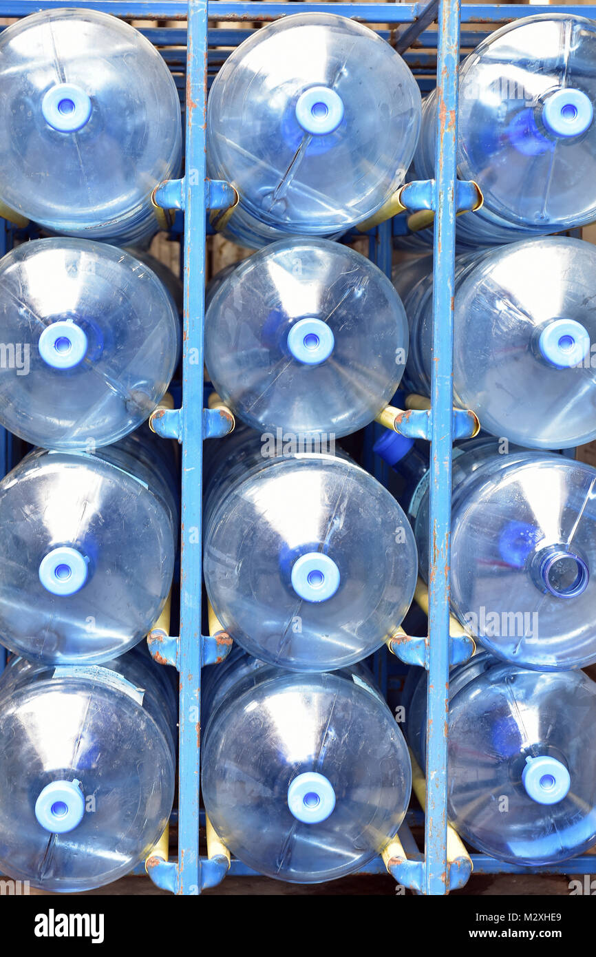 Large plastic water bottles being collected and delivered to a business