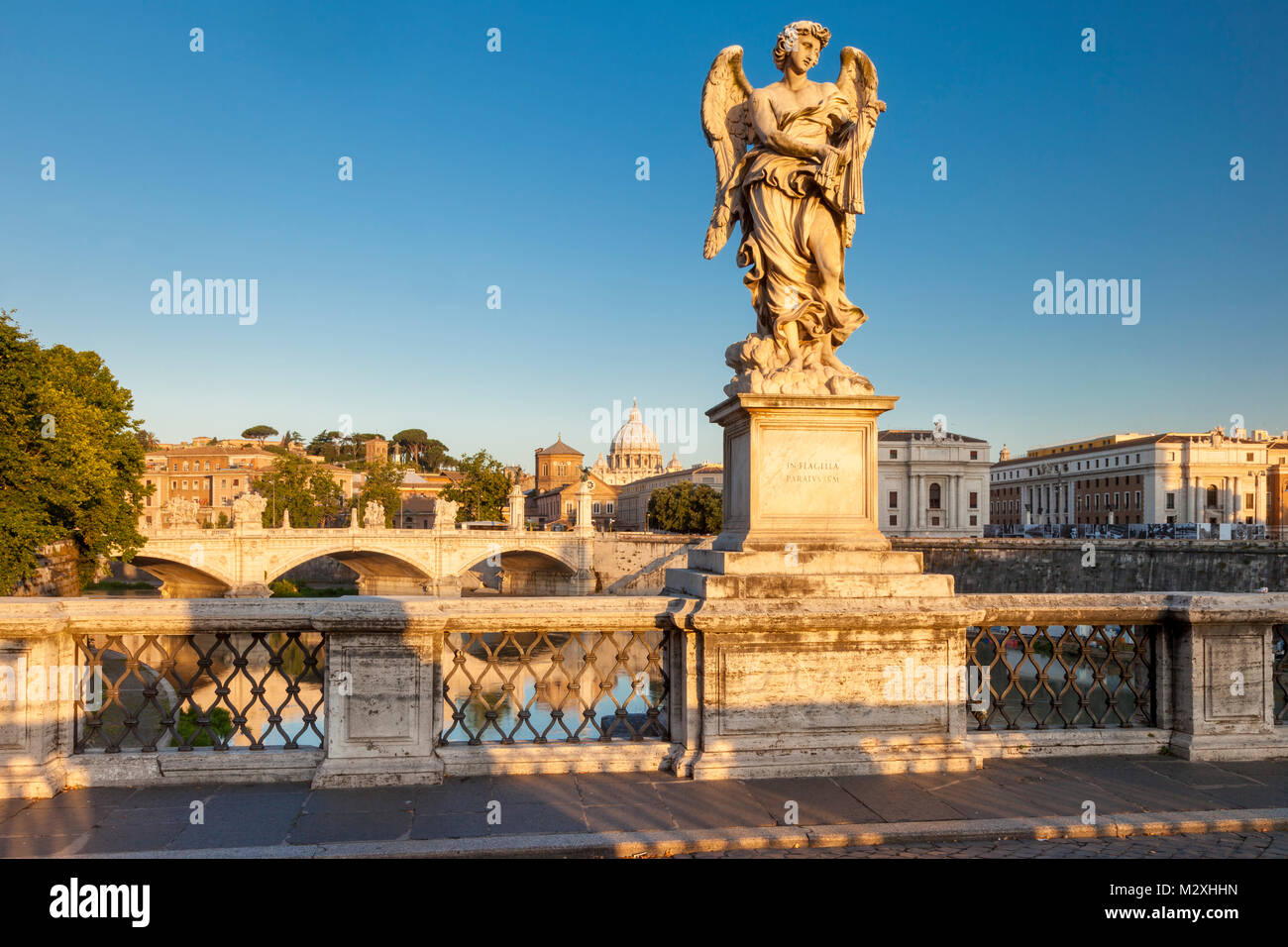 Early morning Angel on Ponte Sant Angelo with St. Peter's Basilica beyond, Rome Lazio Italy Stock Photo